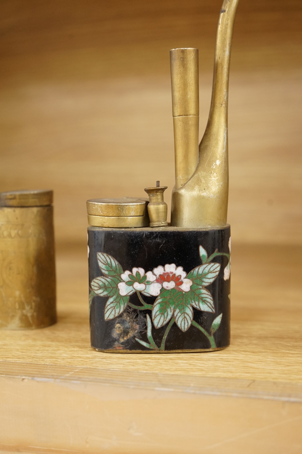A Chinese cloisonné enamel and brass water pipe and an engraved example, largest 36cm high